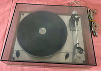 Top-down view under dust cover showing platter, tonearm, control knobs and Thorens logo