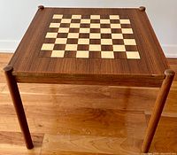 Front view showing chessboard veneer top and cylindrical legs
