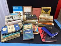 Photo showing the full lot of approximately 30 vintage books arranged on a flat surface, visible book spines and covers include titles on philosophy, politics, sociology, and classic literature.