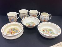 Photo showing all four mugs and three bowls arranged in one group for an overall view of the lot.