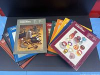 Top down view showing all 10 volumes of The Encyclopedia of Collectibles with colorful covers, each featuring images of collectibles like glassware and antiques.