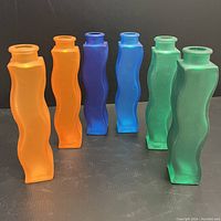 All six IKEA Skamt vintage wavy 'squiggle' glass vases shown from front with orange, blue, and green colors in pairs