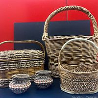 Front view of all five baskets arranged side-by-side showing different styles and varying sizes.