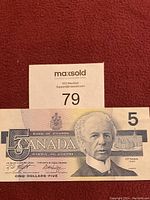 Front side of Canadian 5 dollar bill showing portrait and denomination