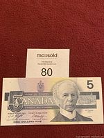 Obverse side of Canadian $5 bill showing Sir Wilfrid Laurier portrait and denomination 5