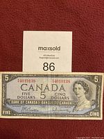 Front side of Canadian five dollar bill showing Queen Elizabeth II portrait, serial number A4019138, and denomination.