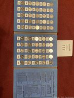 Photo showing three blue album pages with Canadian dimes arranged by year 1971 to 2020, each coin mounted and labeled with its year.