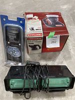 Photo showing three items: packaged Reese Economy Spare Tire Carrier, green flashing car light with wires, and boxed Craftsman 6-inch orbital buffer/polisher.