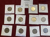 Photo showing 12 USA quarter dollar coins from different states mounted in paper holders with state names.