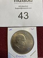 Front side of the coin showing a profile portrait of Winston Churchill with inscription and year 1965.