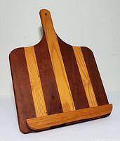 Front view showing two-tone wood vertical stripes and built-in ledge.