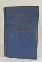 Front cover of the blue hardcover cookbook showing the title embossed in gold.