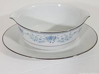 Gravy boat and underplate showing side and top views, highlighting blue floral pattern and platinum trim.