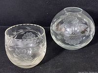 Photo showing two etched glass items: a round rose bowl and a smaller cup/bowl with floral cornflower pattern.
