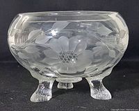Side view of the clear glass footed bowl showing etched cornflower and leaf motifs with three textured feet.