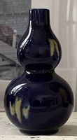 Photo showing cobalt blue porcelain gourd-shaped bud vase with glossy finish and smooth surface, approx. 6 inches tall.