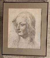 Framed black and white print of a female head with veil, shown fully in frame with matting.