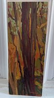 Full view of vertical rectangular painting depicting abstract tree trunks and foliage in warm earthy tones.