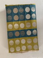 Blue and olive green side of the reversible table runner showing circular brocade motifs.