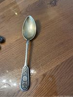 Full view of the antique Russian silver serving spoon showing bowl and handle details.