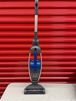 Full view of upright Bissell Lift-Off Floors & More vacuum cleaner with collapsible handle and blue grip.