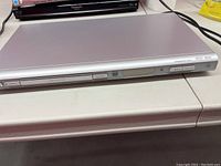 Front and top view of silver Philips DVD player, model DVP642/37 showing disc tray and front controls.