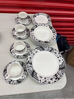 Overview of the Stoneware set arranged showing cups, saucers, bowls, side plates, and dinner plates.