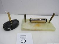 Photo showing both the vintage perpetual calendar on green onyx marble base and the black marble pen holder with gold-tone accents.