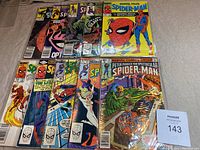 Full layout of the 10 Spider-Man comics showing a variety of issues with prominent colorful covers featuring Spider-Man and other characters, comics are bagged.