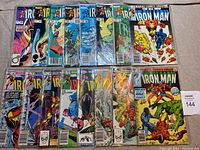 16 Marvel Iron Man comic books from 1980 to 1984, laid out on flat surface, in protective bags