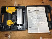 Powerfist 2-in-1 air stapler-nailer tool in case with instruction sheet.