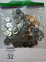 Bulk lot of Canadian 5 cent nickels in a clear plastic bag showing many coins together.