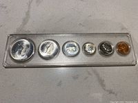 Set of six 1967 Canadian proof coins in clear plastic case, obverse sides with various designs including silver dollar to penny.