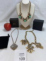 Three J Crew statement necklaces with extender chains, original boxes and dust bag, displayed with apple for scale