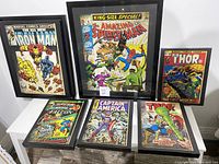 Six framed prints arranged on table