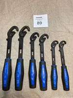 Photo showing six Mastercraft RoboWrench adjustable wrenches arranged on fabric with a MaxSold lot card 89.