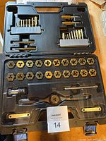 Photo of open carrying case showing the full Maximum tap and die set layout, including taps, dies, and handles in molded slots.