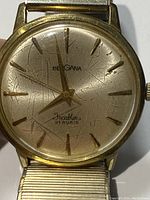 Close-up of watch face showing textured dial surface and scratches