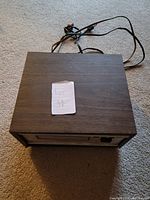 Top view of Concord 8 track tape player showing wood grain finish and power cord.