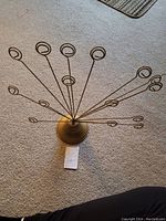 Photo from above showing the radiating wire stems with circular clips for holding pictures.