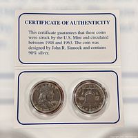 Two Franklin half dollar coins in a display sleeve with Certificate of Authenticity about the coins' silver content and mint dates.