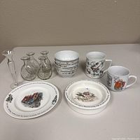 Group shot showing all items: two Peter Rabbit ceramic plates, six small ceramic rice bowls stacked, two coffee cups with floral and vintage food designs, and three clear glass bud vases.