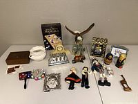 Full lot overview with multiple Millennium 2000 memorabilia items, Mancala game, figurines, and a wooden box