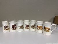 Set of seven white porcelain animal mugs by Lord Nelson Pottery, each with different detailed animal illustrations.