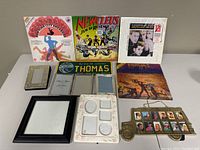Overview of 3 records and assorted photo frames on white table