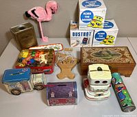 Overview of group showing all toys and banks including Dustbot, Robie the Banker, pink flamingo and assorted banks and toys