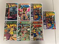 Full view of all seven X-Men comic books laid out on a surface, showing covers and colors.
