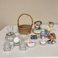 Full lot view showing all items including figurines, glass bottles, a basket, and decorative pieces on table