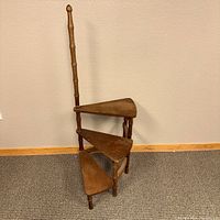 Front view of vintage 3-step library steps showing triangular steps and tall back support.