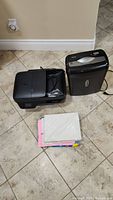 HP OfficeJet 4630 printer, ShredSafe paper shredder, and printer paper visible on tiled floor.